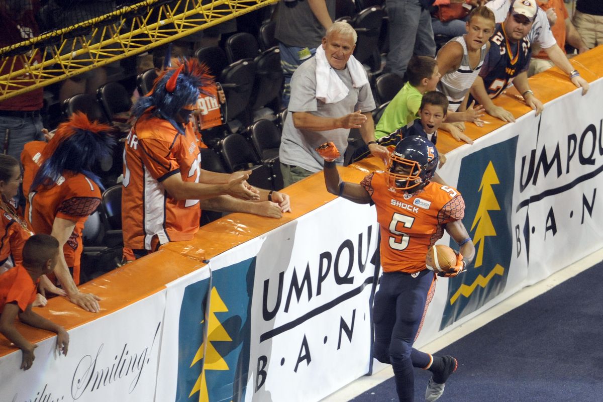 Terrance Sanders of the Spokane Shock runs over to celebrate with fans in the endzone after returning an interception for a touchdown. (Jesse Tinsley)