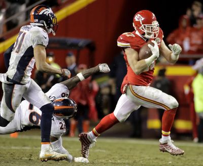 Kansas City Chiefs tight end Travis Kelce, right, carries the ball away from Denver Broncos safety Darian Stewart (26) and safety Justin Simmons (31) during the Chiefs 33-10 win  in Kansas City, Missouri, on Sunday, Dec. 25, 2016. Kelce had 11 catches for 160 yards and one touchdown. (Charlie Riedel / Associated Press)