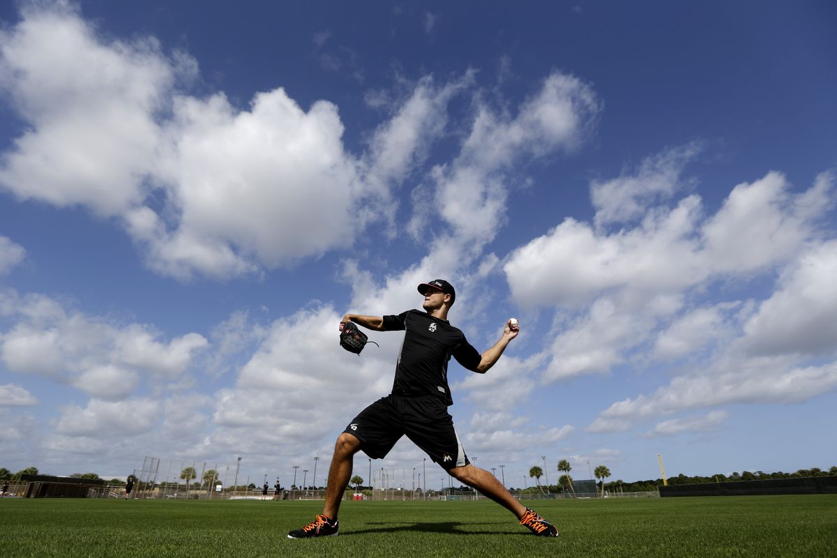Pitcher Dan Jennings gets in some throwing Monday, a day before the official start of the Miami Marlins’ spring training camp. (Associated Press)