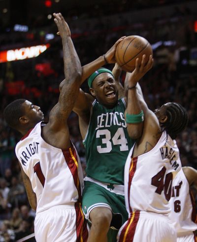 Celtics forward Paul Pierce goes up for a shot against Miami’s Dorell Wright, left, and Udonis Haslem during the second half. (Associated Press)