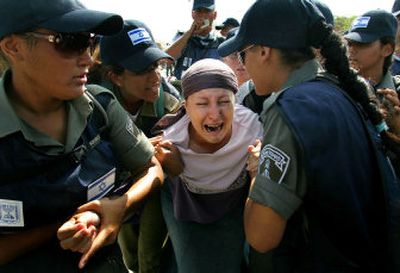 
A Jewish settler cries as she is dragged away by Israeli police officers in the southern Gaza Strip on Wednesday.
 (Associated Press / The Spokesman-Review)