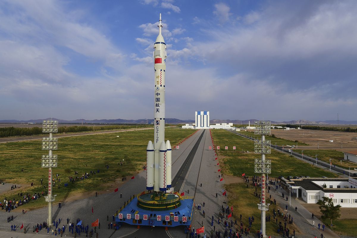 In this photo released by Xinhua News Agency, the Shenzhou-13 manned spaceship atop a Long March-2F carrier rocket is transferred to the launching area of Jiuquan Satellite Launch Center in northwestern China, Oct. 7, 2021. China is preparing to send three astronauts to live on its space station for six months — a new milestone for a program that has advanced rapidly in recent years.  (Wang Jiangbo)