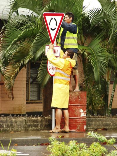 Land Transport Authority workers install traffic signs in Apia, Samoa, on Sunday, a day before the driving-side switch.  (Associated Press / The Spokesman-Review)