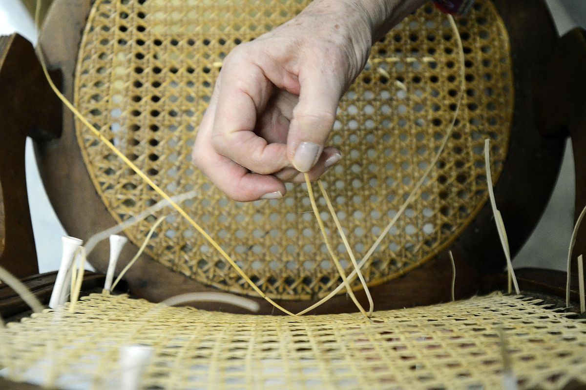 Dorothy Laye, 76, a former math teacher, weaves cane into a side chair on March 29. (John D. Simmons / TNS)