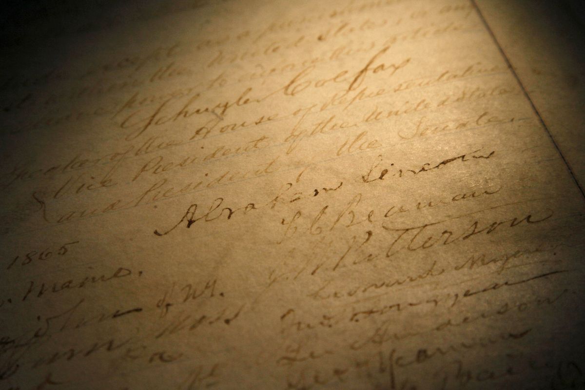 This Nov. 29, 2011, file photo shows the signature of president Abraham Lincoln on a rare, restored copy of the 13th Amendment that ended slavery, in Chicago. National lawmakers are expected on Wednesday, Dec. 2, 2020, to introduce a joint resolution aimed at striking language from the U.S. Constitution that enshrines a form of slavery in America’s foundational documents.  (Charles Rex Arbogast)