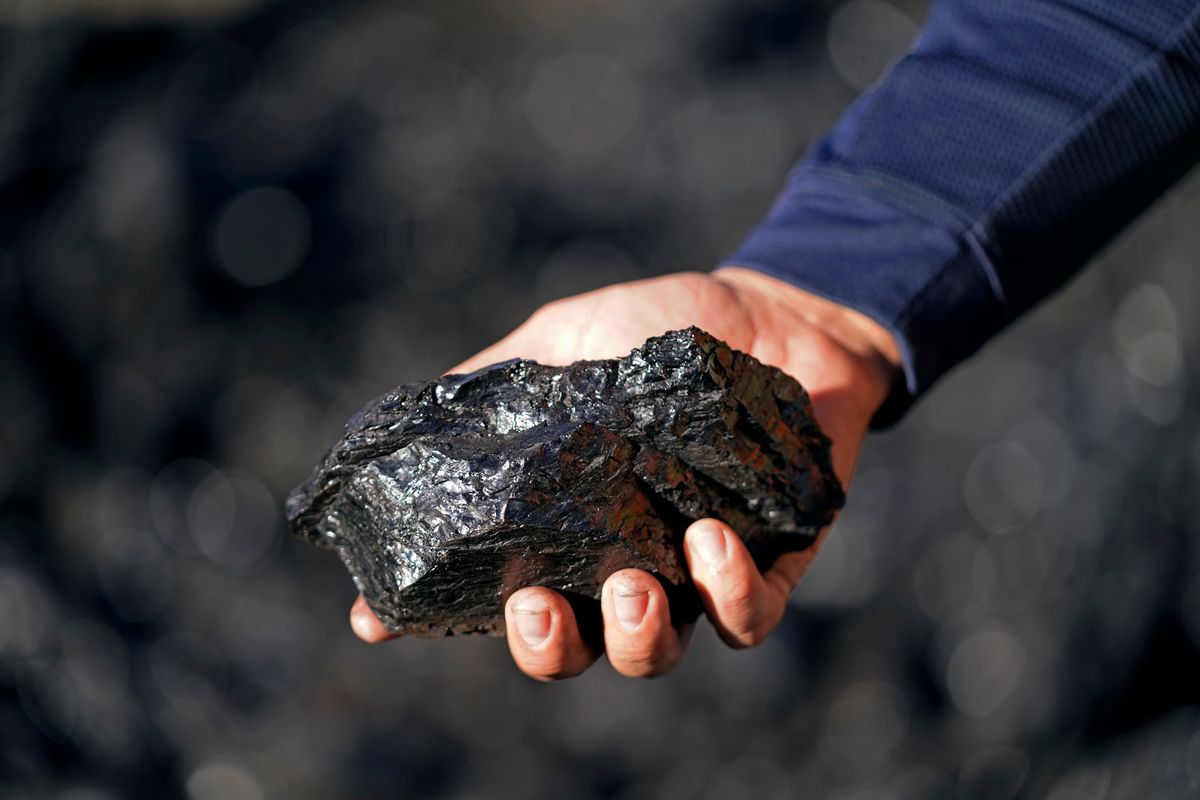 Sean Hovorka, production superintendent Trapper Mining, holds coal from the Trapper Mine on Thursday, Nov. 18, 2021, in Craig, Colo. Hovorka, also recently elected member of the town