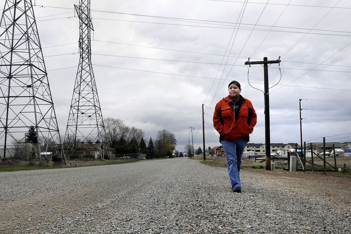Cassandra Cawston, 22, must walk nearly three-quarters of a mile from her Beau Rivage apartment near the corner of Buckeye Avenue and Upriver Drive to catch an STA bus at Buckeye and Myrtle Street.  (Dan Pelle / The Spokesman-Review)