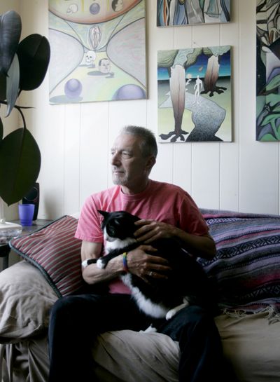 John Krumm holds his cat, Ozzie, at his apartment in San Francisco on Aug. 7. The state employee is helping California balance its budget by taking three unpaid days off each month. McClatchy-Tribune (McClatchy-Tribune / The Spokesman-Review)