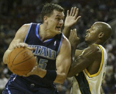 
Matt Harpring, who helped lead Utah to victory Friday night, is called for an offensive foul against Seattle's Ray Allen. 
 (Associated Press / The Spokesman-Review)