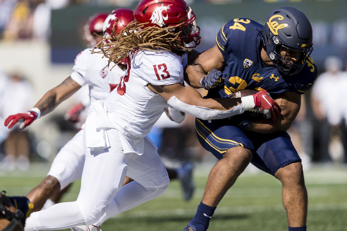 Washington State linebacker Jahad Woods tackles California running back Christopher Brooks during the first quarter of a Pac-12 Conference game Saturday in Berkeley, California. WSU’s defense held California scoreless for the final three quarters.  (John Hefti)
