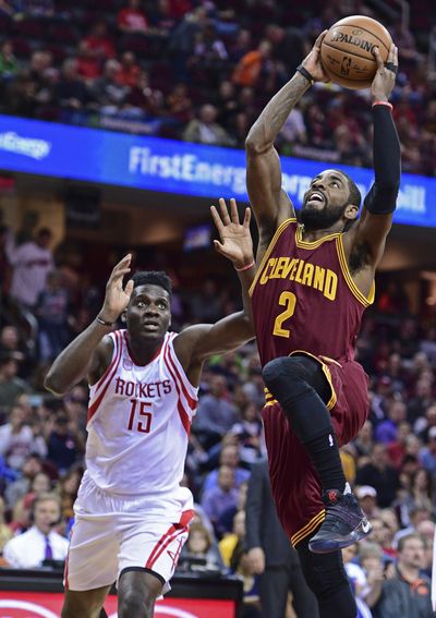 Cavaliers’ Kyrie Irving beats Rockets’ Clint Capela for a dunk. (David Dermer / Associated Press)
