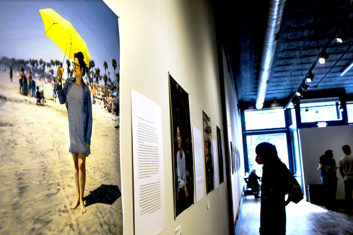 People gather before the closing ceremony of the Terrain exhibit “Hidden in Plain Sight” hosted by APIC Spokane for heritage month on Friday.  (Kathy Plonka/The Spokesman-Review)