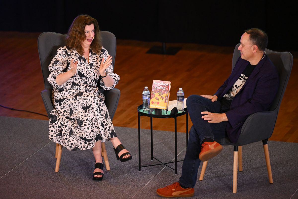 Author Moira Macdonald, chats with NWP alum & bestselling author, Jamie Ford at a gathering of the Northwest Passages Book Club on Tuesday, Jun. 24, 2025, at the Myrtle Woldson Performing Arts Center in Spokane, Wash. Macdonald’s new book "Storybook Ending,” is a charming story about romance, friendship, and a love of books, in which two women - a lonely remote worker and a widowed single mom- and a handsome local bookstore clerk find themselves in an unusual love triangle when an anonymous note left in a book finds the wrong recipient. (Tyler Tjomsland/The Spokesman-Review)