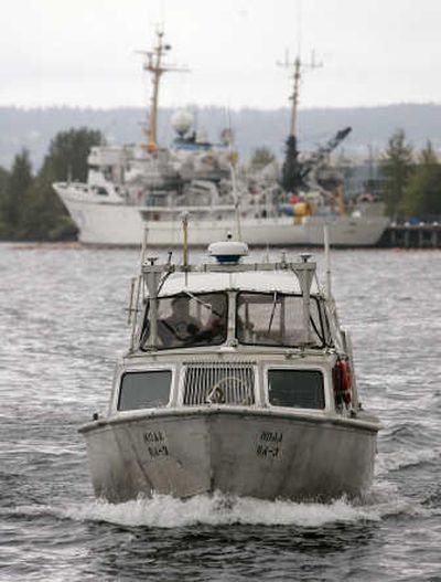 
A small NOAA boat is driven near the docked NOAA ship Rainier at a temporary moorage on Lake Washington on Monday in Seattle. Associated Press
 (Associated Press / The Spokesman-Review)