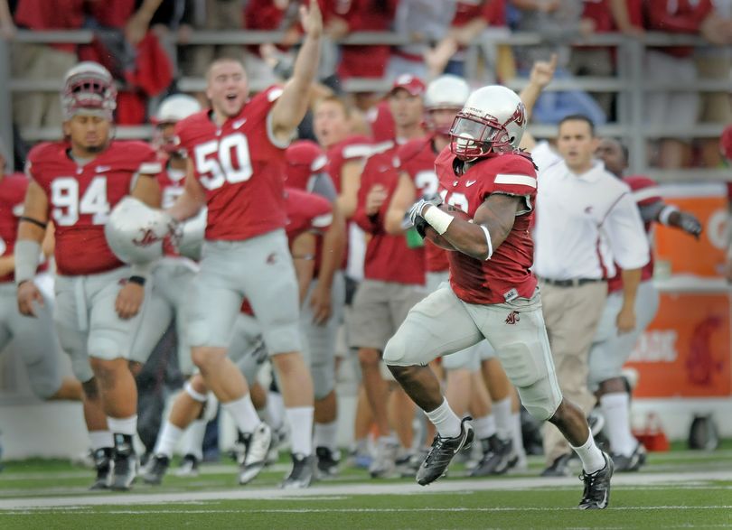 The Washington State sideline starts to celebrate Saturday as linebacker Myron Beck takes an interception back for a touchdown. (CHRISTOPHER ANDERSON / The Spokesman-Review)
