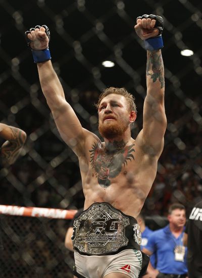 Conor McGregor celebrates after defeating Chad Mendes. (Associated Press)