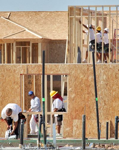 FILE – Workers frame homes at a construction site in Arizona, which has tried to crack down on employers who hire illegal immigrants. The underground economy is a hot-button item of discussion on the right and the left. (MATT YORK / AP)