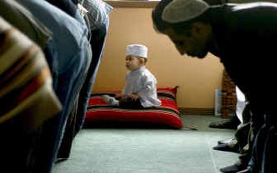 
Mohammad Gilliard, age 10 months, sits patiently during Al-Juma prayers Friday at the Spokane Islamic Center. 
 (Colin Mulvany / The Spokesman-Review)