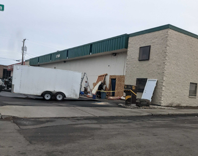 Workers on Friday, Nov. 25, 2022, were repairing damage caused by burglars at Precision Combat Arms, 1710 E. Trent Ave.  (Emry Dinman/The Spokesman-Review)