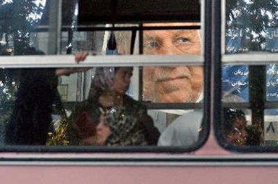 
A poster of former Iranian President Akbar Hashemi Rafsanjani, who will face Tehran's hard-line mayor in Iran's first runoff presidential election in its history, is seen through a public bus in Tehran on Sunday. 
 (Associated Press / The Spokesman-Review)