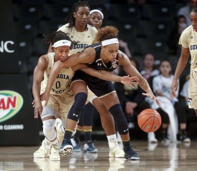 Georgia Tech guard Imani Tilford (0) tries to steal the ball from Notre Dame forward Brianna Turner, center, in the second half of an NCAA college basketball game, Monday, Jan. 2, 2017, in Atlanta. Notre Dame won 55-38. (John Bazemore / Associated Press)