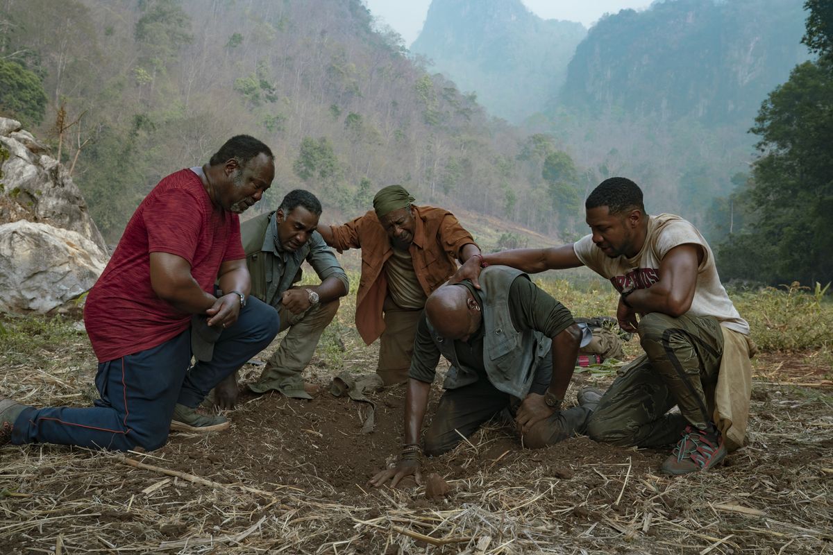 This image released by Netflix shows, from left, Isiah Whitlock Jr., Norm Lewis, Clarke Peters, Delroy Lindo and Jonathan Majors in a scene from the Spike Lee film "Da 5 Bloods."  (David Lee)