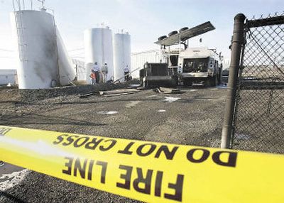 
Investigators look over the aftermath of an explosion at Lawrence Oil Co. in Othello, Wash., on Wednesday. 
 (Associated Press / The Spokesman-Review)
