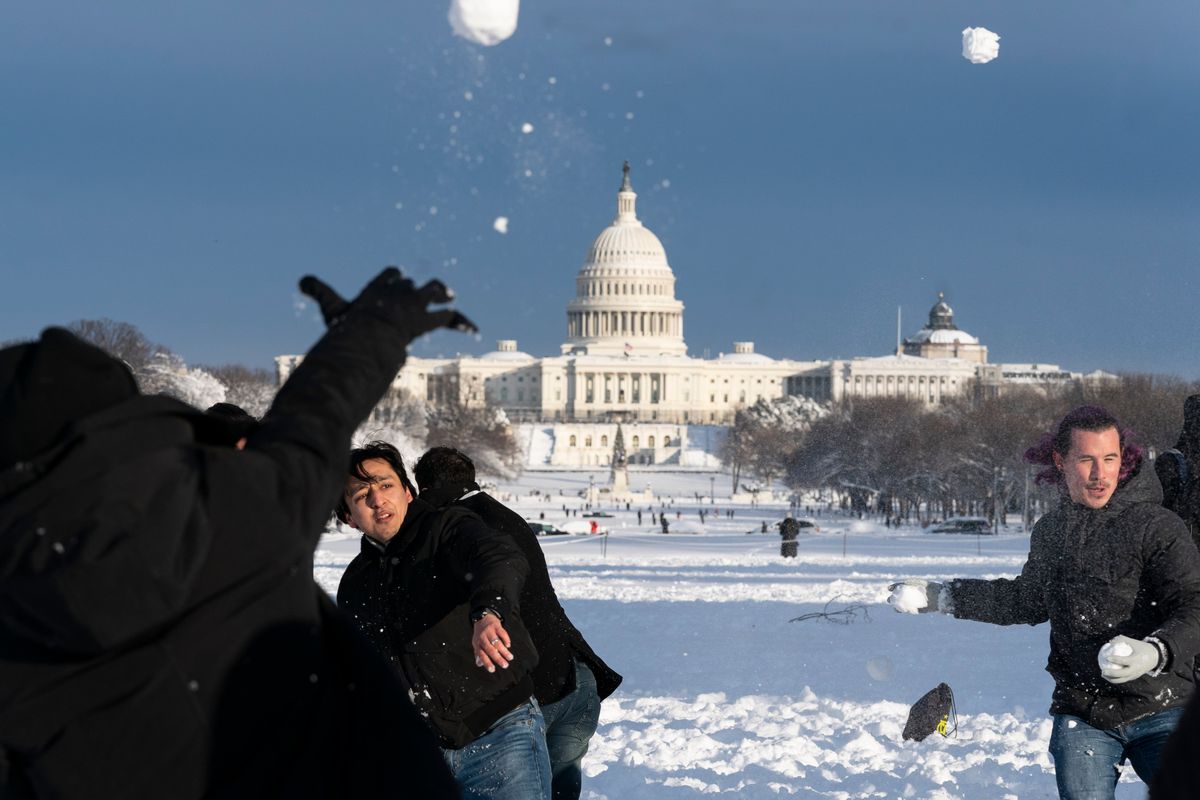 Snowballs fly during a snowball fight organized by the DC Snowball Fight Association, on the National Mall, Monday, Jan. 3, 2022, in Washington.  (Alex Brandon)