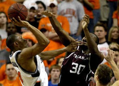 
Oklahoma State forward Joey Graham, left, shoots in front of Texas A&M center Joseph Jones, center, and Chris Walker, right, in the second half in Stillwater, Okla.
 (Associated Press / The Spokesman-Review)