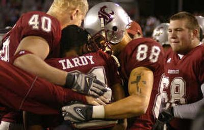 
Dwight Tardy is swarmed by teammates after his final scoring run.
 (Christopher Anderson / The Spokesman-Review)