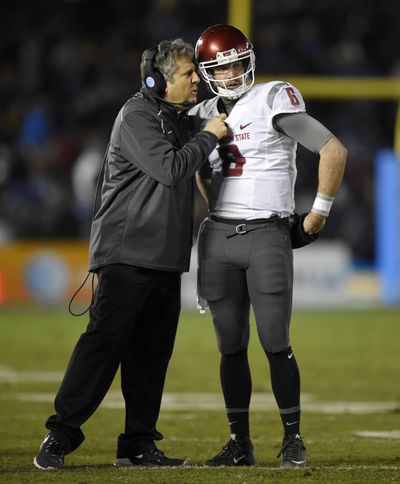 Washington State head coach Mike Leach, left, talks with quarterback Peyton Bender during the first half of an NCAA college football game against UCLA, Saturday, Nov. 14, 2015, in Pasadena, Calif. Bender will start the Apple Cup in place of injured starting QB Luke Falk. (Mark Terrill / Associated Press)