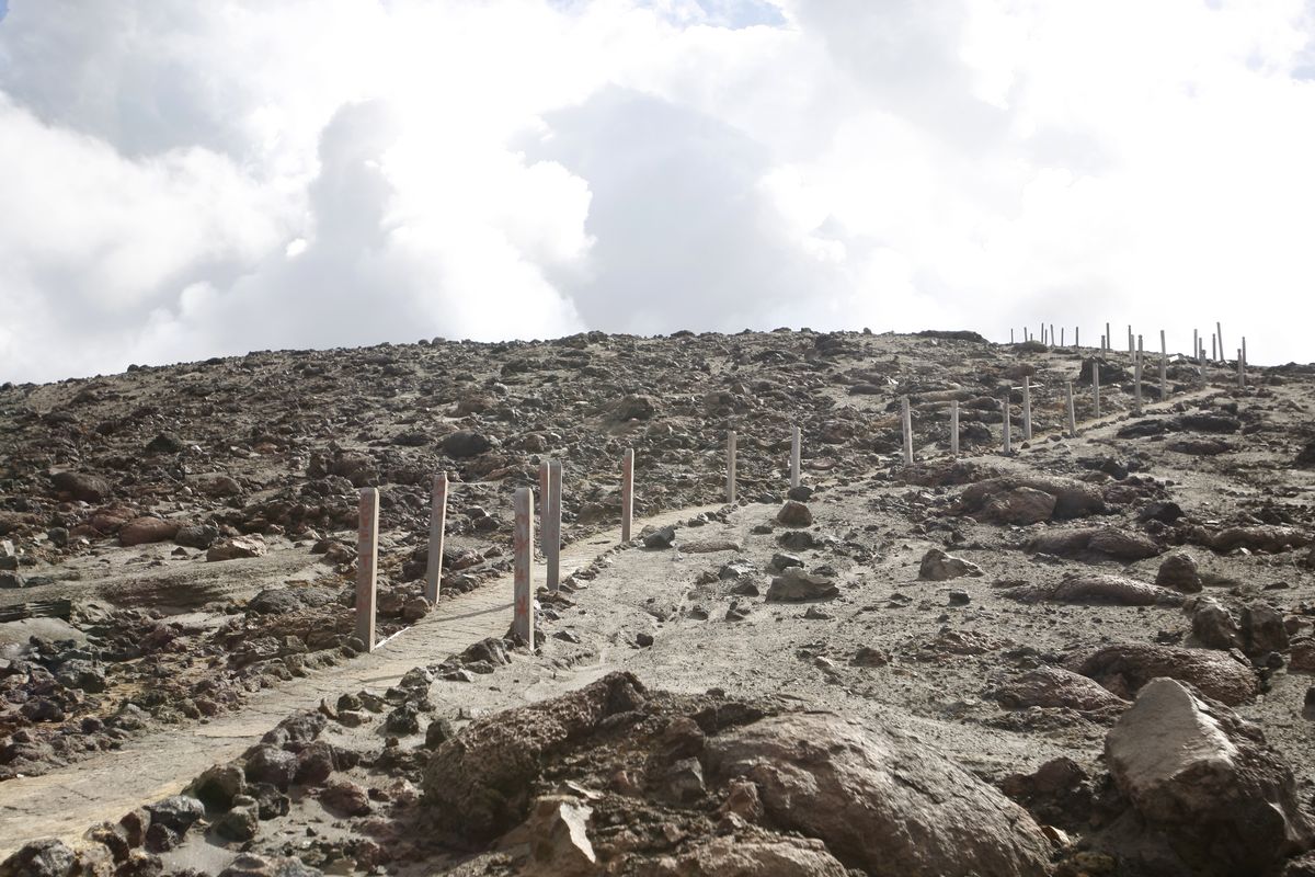 At left: A walking path leads up a barren moonscape on Yasur volcano. Geologist Yoram Teitler says the volcano has been active for perhaps 2,000 years. (Associated Press)