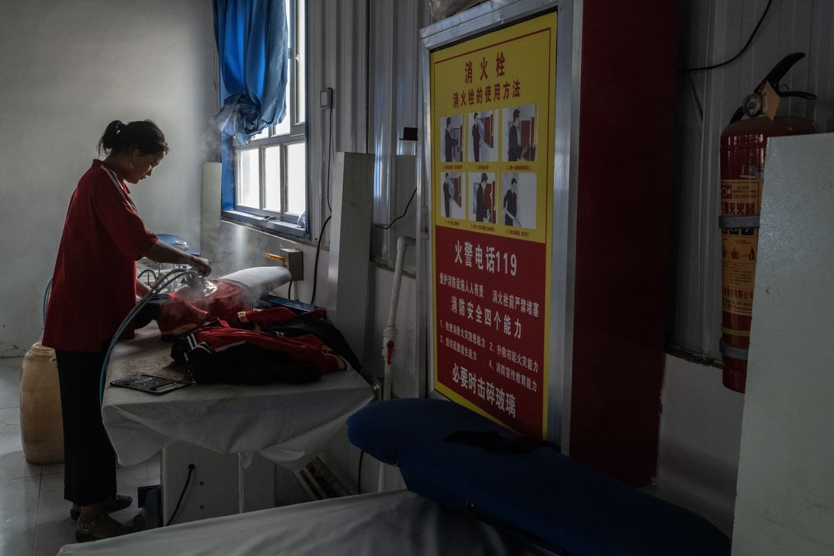 A Uyghur women works in a garment factory in Horan, in China’s Xinjiang province, in August 2019.  (GILLES SABRIE)