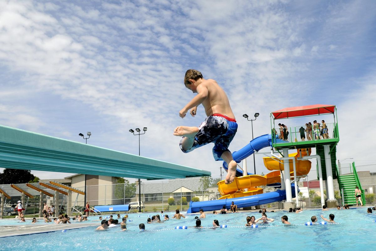 Michael Miethe, 8, adds a little twist to his jump off the diving board on the opening day of swimming at the Hillyard Pool, June 14, 2010, in Spokane. (DAN PELLE/The Spokesman-Review)
