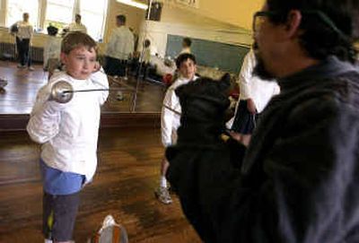 Fencer Mike Winderman, right, demonstrates a beginner's exercise with student Blake Alfson during regular lessons Wednesday night in Coeur d'Alene. Winderman is organizing a stage combat class with a top instructor for August.
(Jesse Tinsley / The Spokesman-Review)