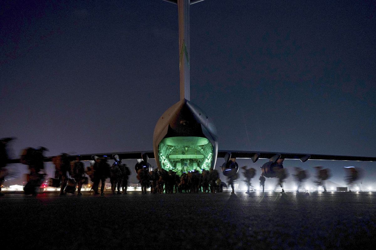 In this Aug. 30, 2021, file photo provided by the U.S. Air Force, soldiers, assigned to the 82nd Airborne Division, prepare to board a U.S. Air Force C-17 Globemaster III aircraft at Hamid Karzai International Airport in Kabul, Afghanistan. (Senior Airman Taylor Crul)