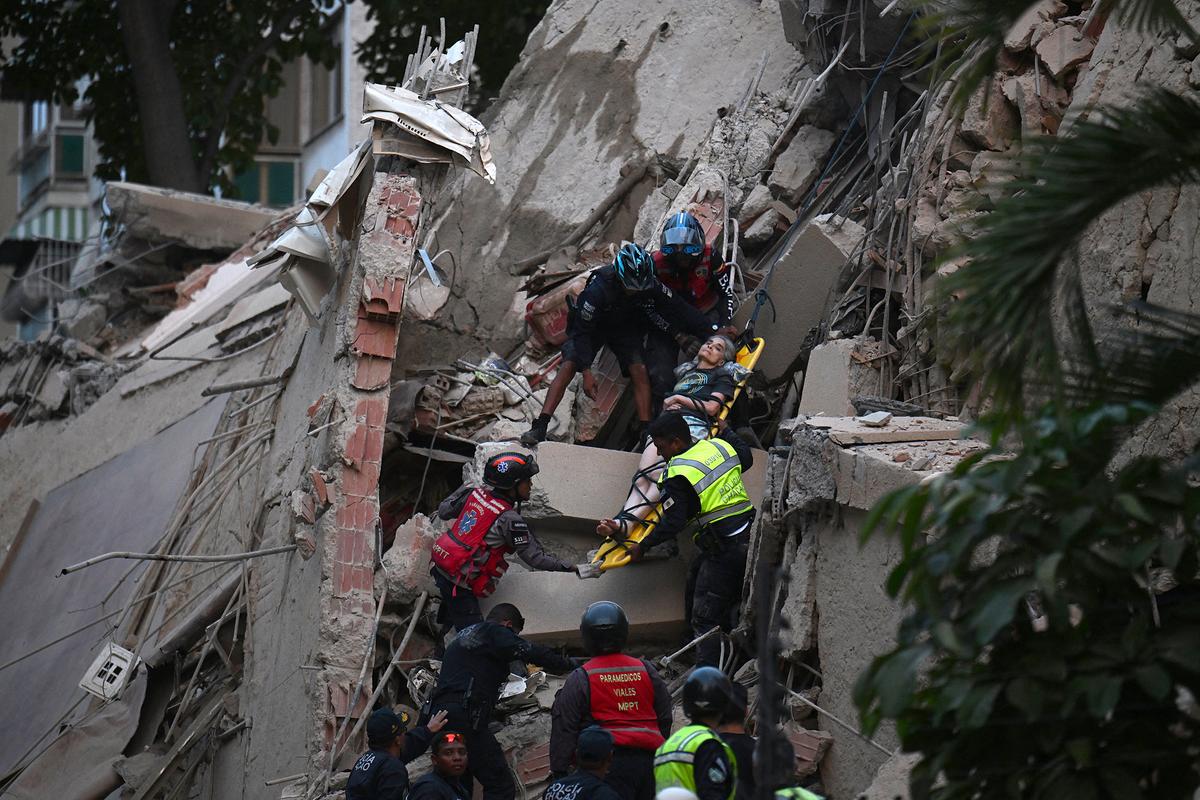 Rescue workers carry a person on a stretcher out of a collapsed building following an earthquake in Caracas on June 24, 2026. Two earthquakes of magnitude 7.2 and 7.5 struck the same area of Venezuela on the evening of June 24, causing buildings to collapse, according to the United States Geological Survey (USGS) and AFP journalists. The quakes drove residents of the capital, Caracas, into the streets.   (Juan Barreto/AFP/Getty Images/TNS)