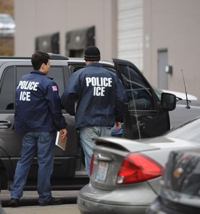U.S. Immigration and Customs Enforcement agents leave the Yamato Engine Specialist plant in Bellingham on Tuesday morning after raiding the plant for illegal immigrants.  (Associated Press / The Spokesman-Review)