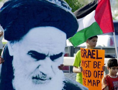
Iranian demonstrators carry a cutout of the late Ayatollah Ruhollah Khomeini, a Palestinian flag and an anti-Israel sign at a rally in Manama, Bahrain, on Friday. 
 (Associated Press / The Spokesman-Review)