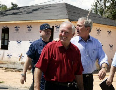 
President Bush  tours a neighborhood damaged by Hurricane Katrina with Biloxi, Miss., Mayor A.J. Holloway on Monday. 
 (Associated Press / The Spokesman-Review)