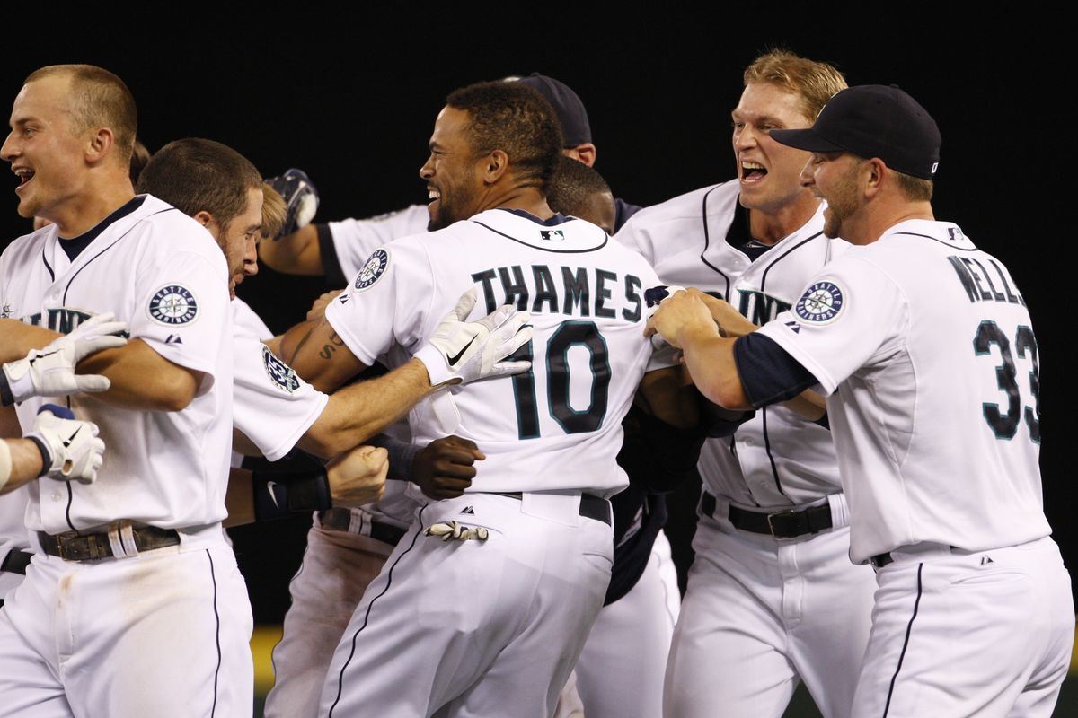 Eric Thames receives cheers after his winning hit. (Associated Press)