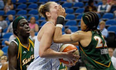 
Minnesota Lynx's Nicole Ohlde takes a hand to the face from Betty Lennox. Associated Press
 (Associated Press / The Spokesman-Review)