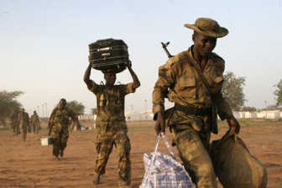
African Union peacekeepers evacuate a camp Sunday in the north of Sudan's Darfur region. Associated Press
 (Associated Press / The Spokesman-Review)