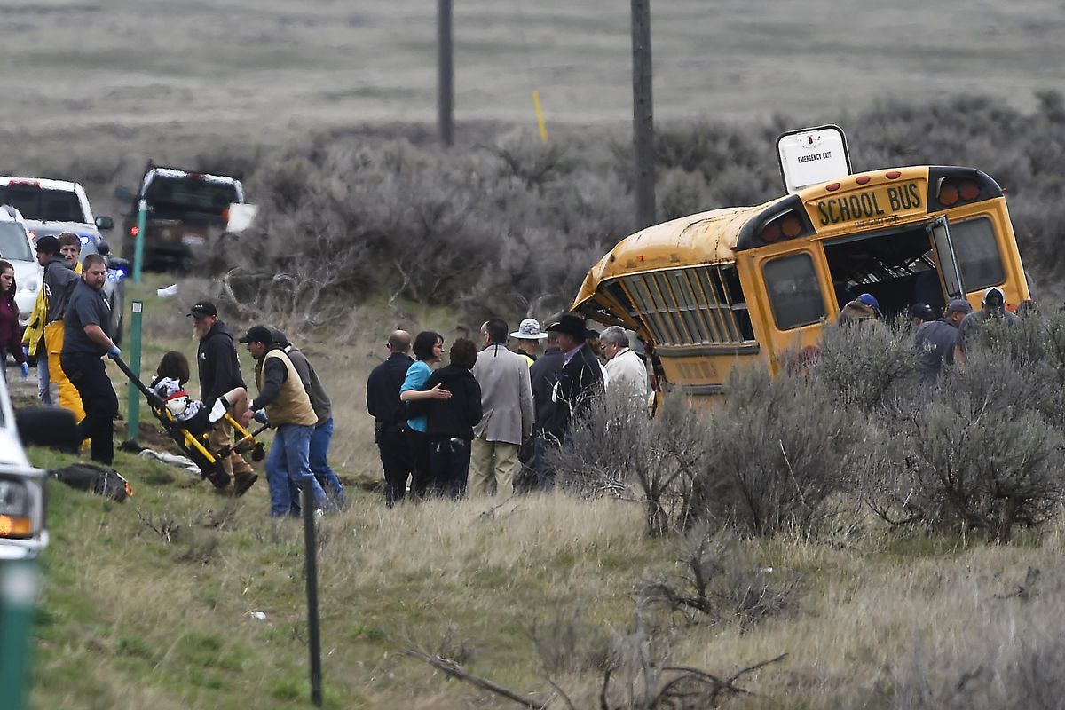 Emergency personnel help to remove passengers after a school bus crashed  Tuesday, April 18, 2017, west of Richfield, Idaho. (DREW NASH / Times-News)