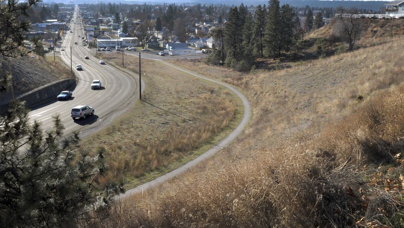 Traffic winds its way north up the Monroe Street hill on Friday past vacant property the city of Spokane is considering selling for an apartment complex. (Christopher Anderson)