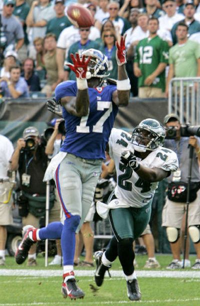 
New York Giants receiver Plaxico Burress hauls in a touchdown pass from Eli Manning. 
 (Associated Press / The Spokesman-Review)