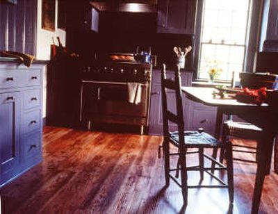 It may look like the floor in an old farmhouse kitchen, but it's really a ringer — hard-wearing, modern laminate. The pattern is Aged Heart Pine by Formica.
(Associated Press / The Spokesman-Review)