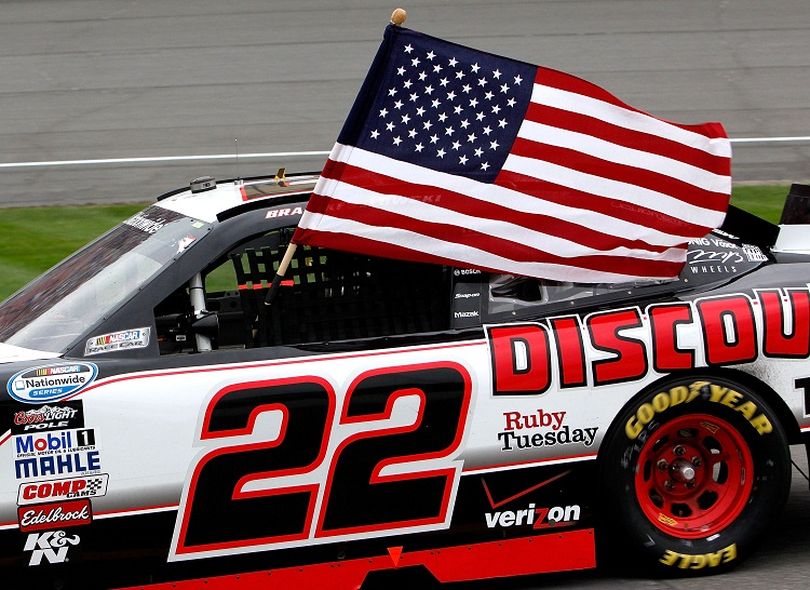 Brad Keselowski waves an American flag out of his window in celebration of winning the NASCAR Nationwide Series CARFAX 250 at Michigan International Speedway on Saturday. (Photo courtesy of Jeff Zelevansky/Getty Images for NASCAR) (Jeff Zelevansky / Getty Images North America)