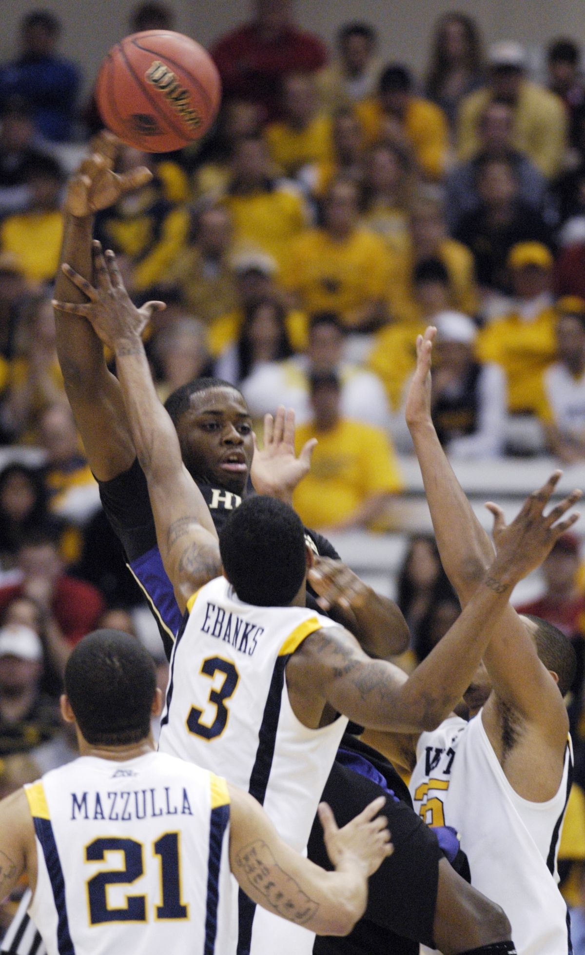 West Virginia’s swarming defense harasses Washington’s Matthew Bryan-Amaning.  (Associated Press)