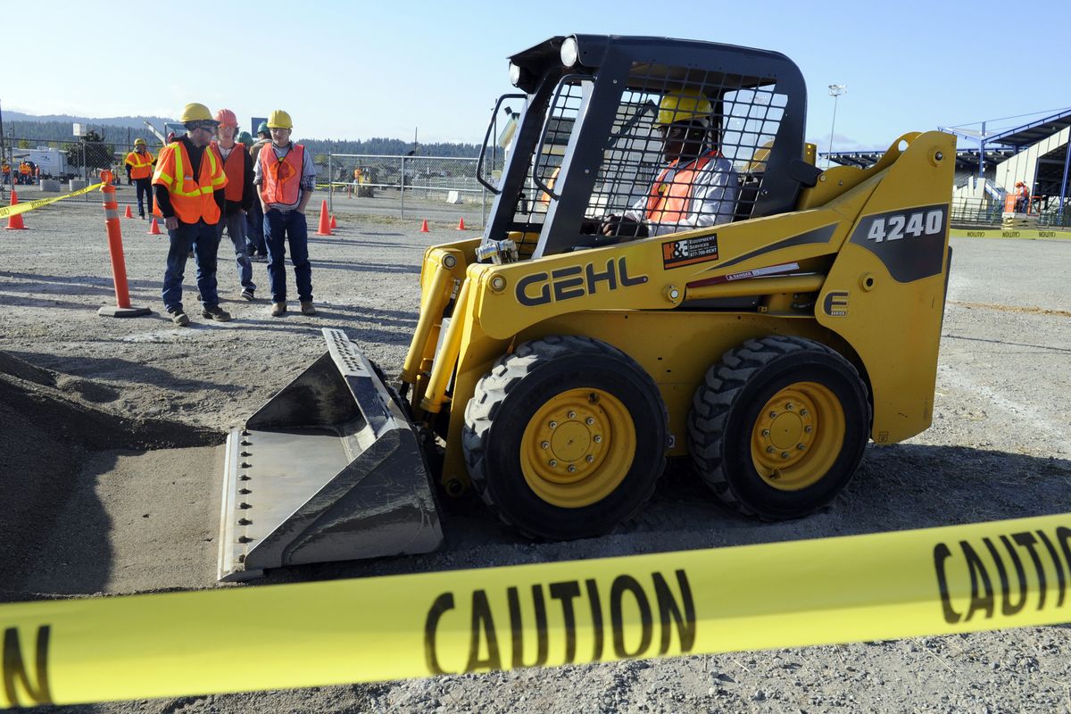 bartr@spokesman.com University High senior Ronnie Lewis tries driving a Bobcat during Career Construction Day. When asked why he asked to attend the event, Lewis said, “I heard it was fun.” (J. Bart Rayniak / The Spokesman-Review)